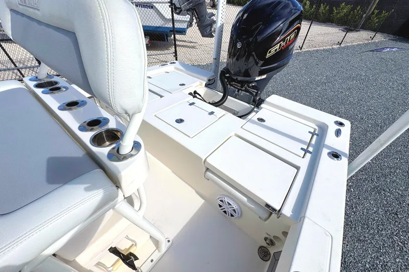 Slide: The Image of 2023 Pathfinder 2200 TRS boat interior with seating and outboard motor. - 6