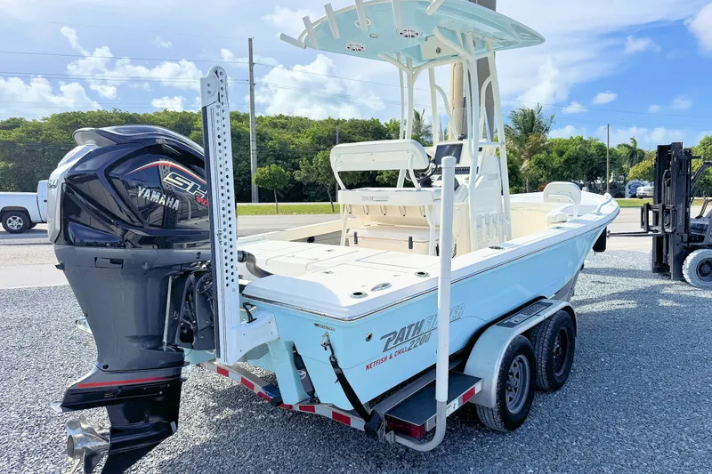Slide: The Image of 2023 Pathfinder 2200 TRS boat with Yamaha engine on trailer, parked outdoors. - 3