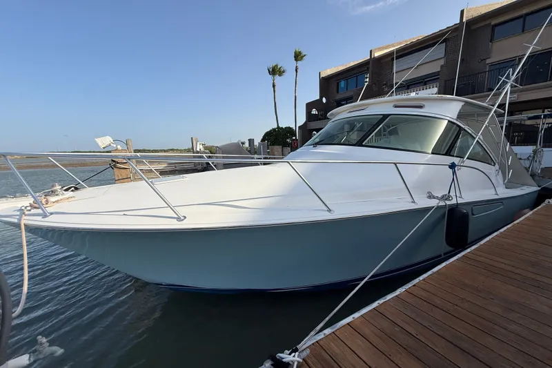 The Image of 2012 Viking 42 Open yacht docked at marina, featuring sleek design and spacious deck. - 0