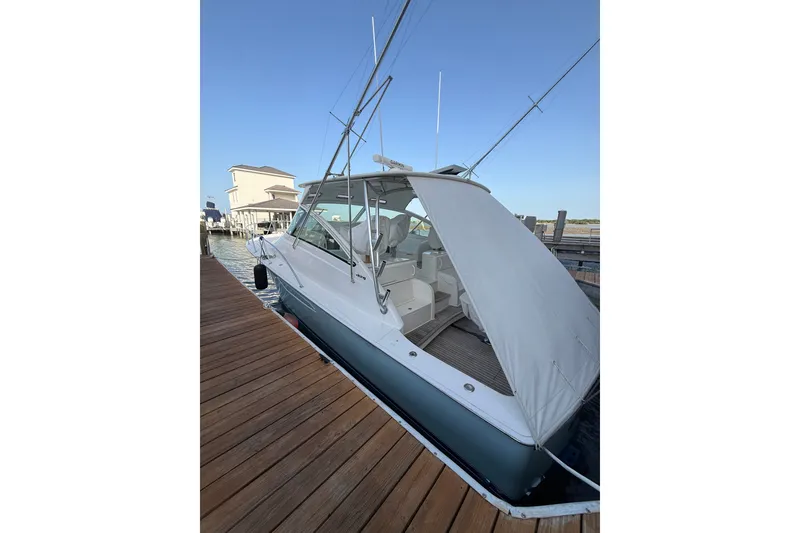Slide: The Image of 2012 Viking 42 Open yacht docked, featuring sleek design and spacious interior. - 1