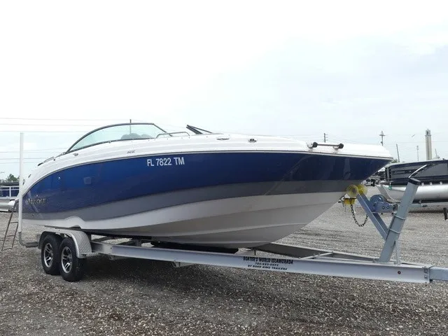 Slide: The Image of A blue and white 2023 NauticStar 243 DC boat is on a trailer. - 4