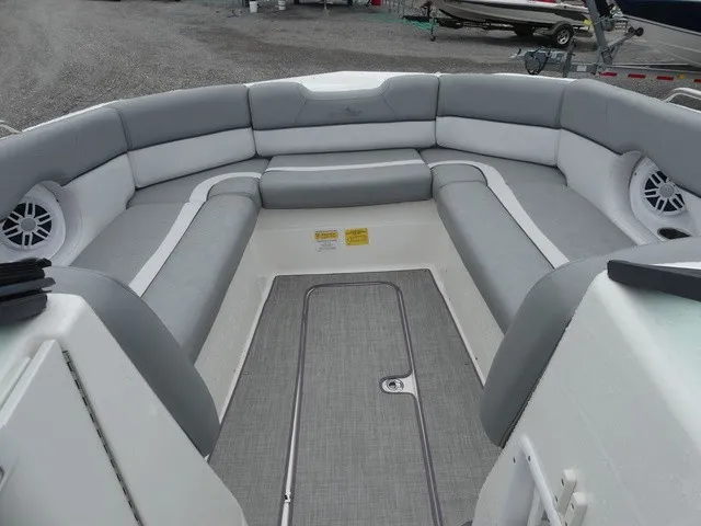 Slide: The Image of The image shows the bow area of a 2023 NauticStar 243 DC boat with gray upholstery. - 13