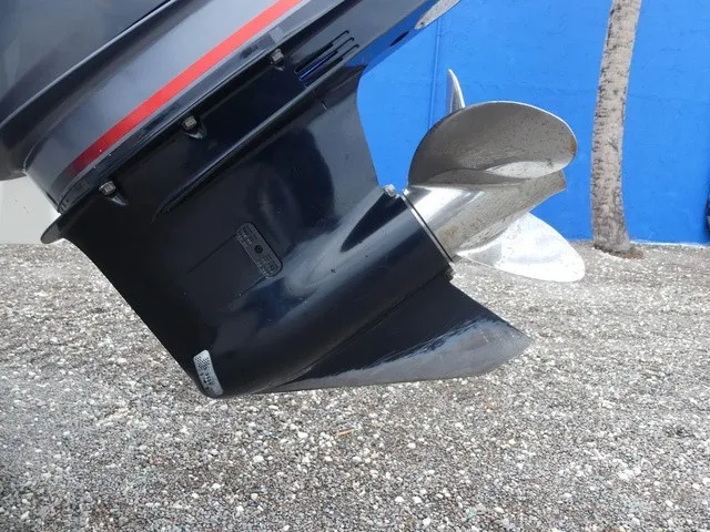 Slide: The Image of Close-up of a boat propeller on a gravel surface, with a blue background. - 11