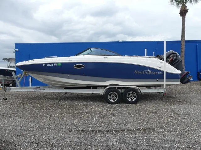 Slide: The Image of A blue and white boat on a trailer, featuring an outboard motor and enclosed cockpit. - 7