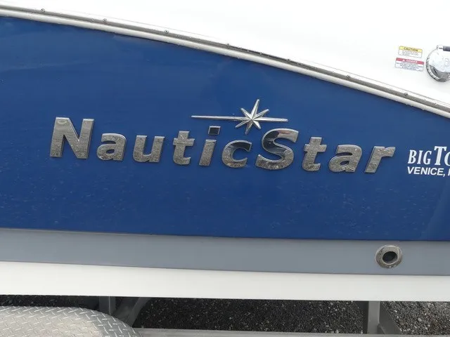 Slide: The Image of Close-up of the blue hull of a 2023 NauticStar 243 DC boat. - 8