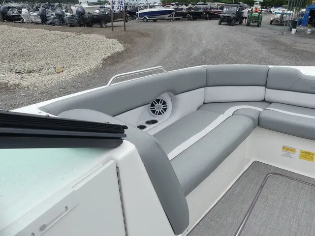 Slide: The Image of The image shows the gray and white seating area of a NauticStar 243 DC boat. - 15