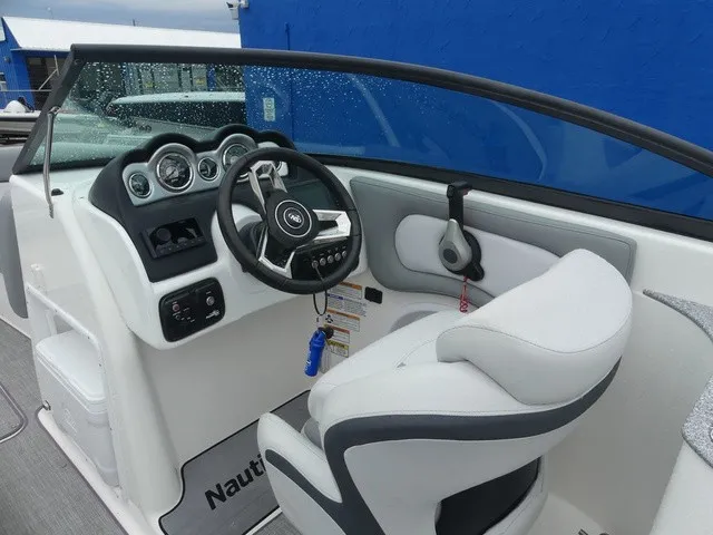 Slide: The Image of The image shows the cockpit of a NauticStar 243 DC boat with a modern helm. - 16