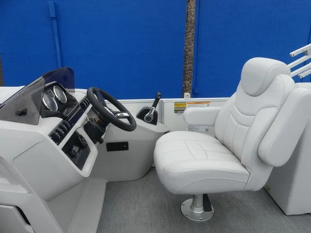 Slide: The Image of The image shows the helm of a 2024 Sweetwater SW 2286 SB boat with a cushioned captain's chair. - 18
