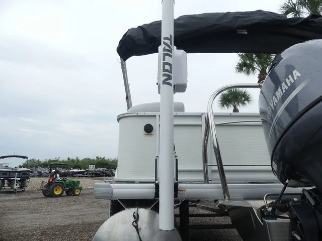 Slide: The Image of A 2024 Sweetwater SW 2286 SB pontoon boat with a Yamaha outboard motor, parked on a gravel lot. - 13
