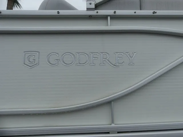 Slide: The Image of Close-up of the Godfrey logo on a Sweetwater SW 2286 SB pontoon boat. - 8