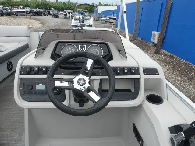 Slide: The Image of The image shows the helm of a 2024 Sweetwater SW 2286 SB boat with modern instruments. - 19