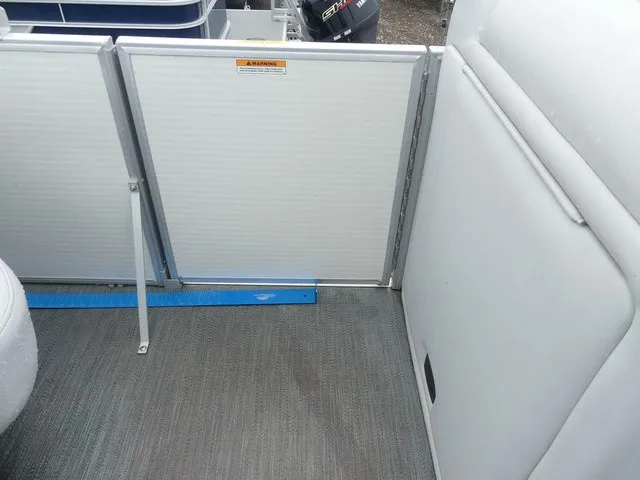Slide: The Image of Interior view of a 2024 Sweetwater SW 2286 SB with gray carpeting and white upholstery. - 29