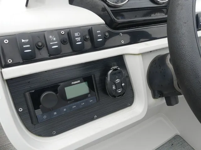 Slide: The Image of The image shows the dashboard of a Sweetwater SW 2286 SB boat with various controls and a Fusion audio system. - 21