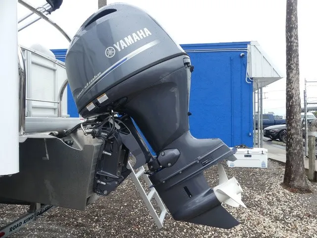 Slide: The Image of A Yamaha outboard motor is mounted on a boat, which is on a gravel surface. - 10
