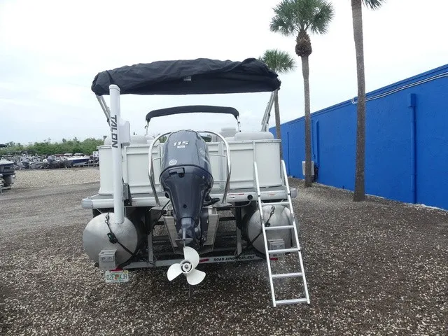 Slide: The Image of A 2024 Sweetwater SW 2286 SB pontoon boat with an outboard motor and ladder at the rear. - 7