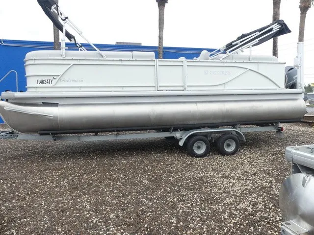Slide: The Image of A 2024 Sweetwater SW 2286 SB pontoon boat on a trailer, ready for transport. - 6