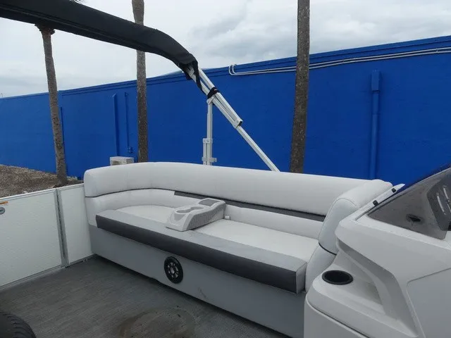 Slide: The Image of The image shows the rear seating of a 2024 Sweetwater SW 2286 SB pontoon boat with gray upholstery. - 17
