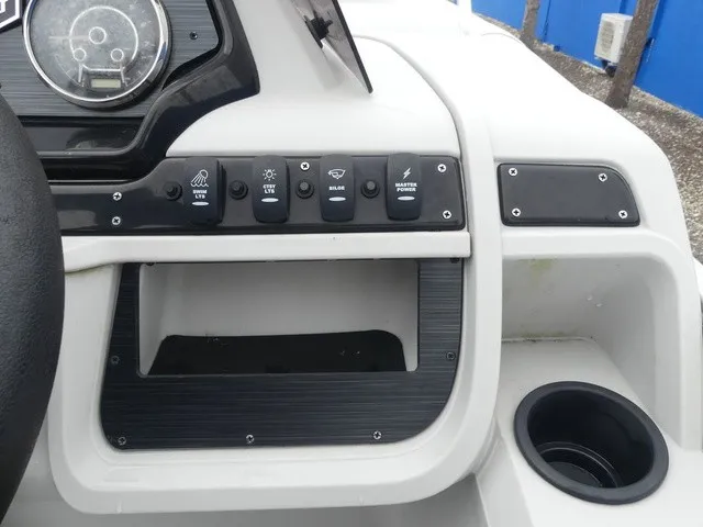 Slide: The Image of The image shows the dashboard of a Sweetwater SW 2286 SB boat with various switches. - 22