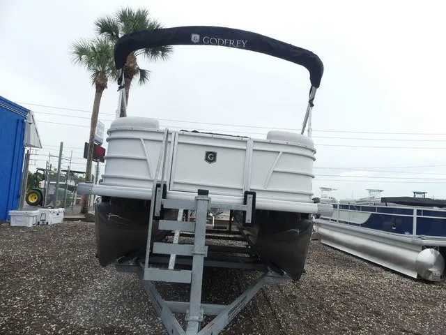 Slide: The Image of A 2024 Sweetwater SW 2286 SB pontoon boat on a trailer, featuring a black sunshade. - 3