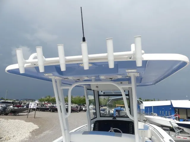 Slide: The Image of The image shows the top deck of a Robalo R272 Center Console boat with fishing rod holders. - 12