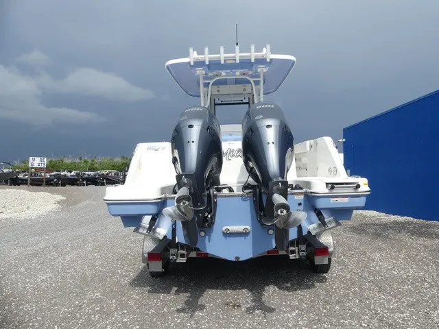 Slide: The Image of The image shows the rear of a 2022 Robalo R272 Center Console boat with two outboard engines. - 6