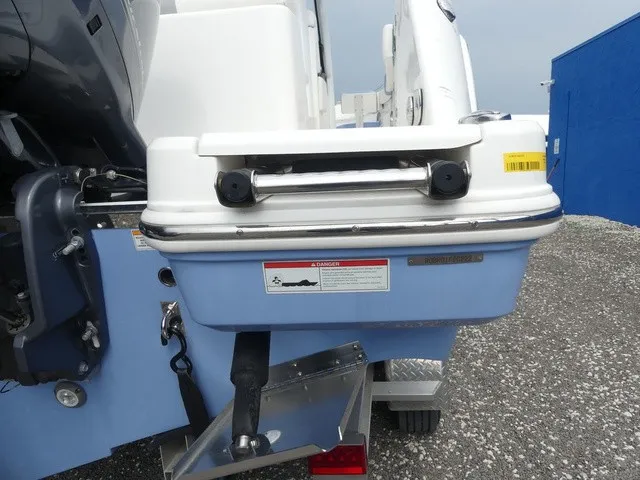 Slide: The Image of The image shows the stern of a 2022 Robalo R272 Center Console boat with an outboard motor. - 34