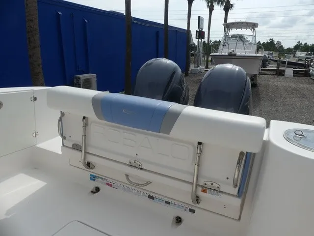 Slide: The Image of The image shows the stern of a 2022 Robalo R272 Center Console boat with two outboard motors. - 16