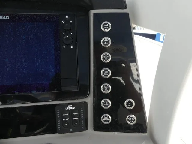 Slide: The Image of The image shows the dashboard of a Robalo R272 Center Console boat with various controls. - 25