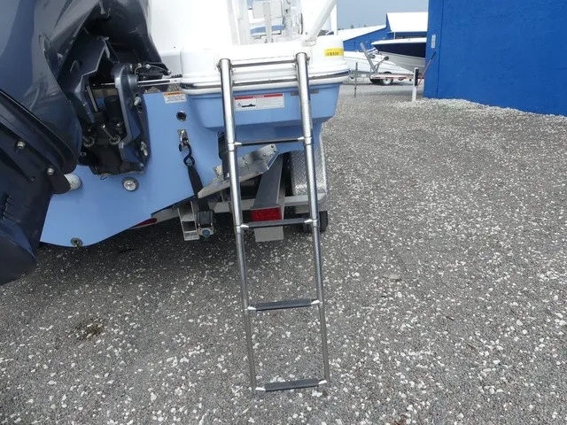 Slide: The Image of A swim ladder is attached to the stern of a boat, which is on a gravel lot. - 33