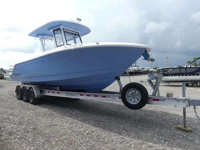 Slide: The Image of A blue 2022 Robalo R272 Center Console boat on a trailer, ready for transport. - 4