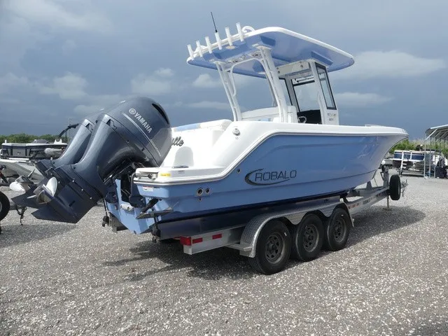 Slide: The Image of A 2022 Robalo R272 Center Console boat on a trailer, featuring a Yamaha outboard motor. - 5