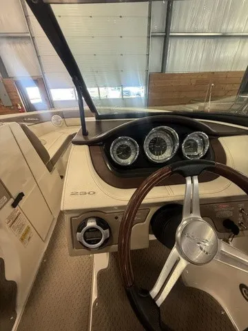 Slide: The Image of The image shows the cockpit of a 2013 Sea Ray SLX 230 with a sleek dashboard. - 12