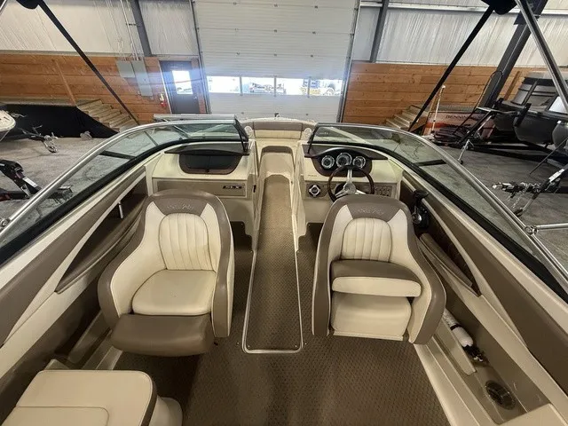 Slide: The Image of Interior view of a 2013 Sea Ray SLX 230 boat with beige and white seating. - 8