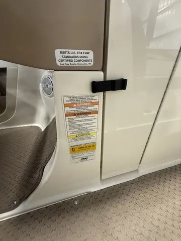 Slide: The Image of Close-up of a boat interior with warning labels and carpeted flooring. - 14