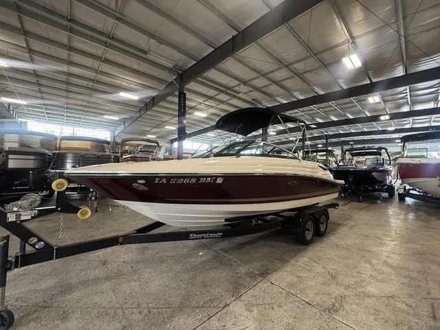 Slide: The Image of A 2013 Sea Ray SLX 230 boat on a trailer inside a warehouse. - 6