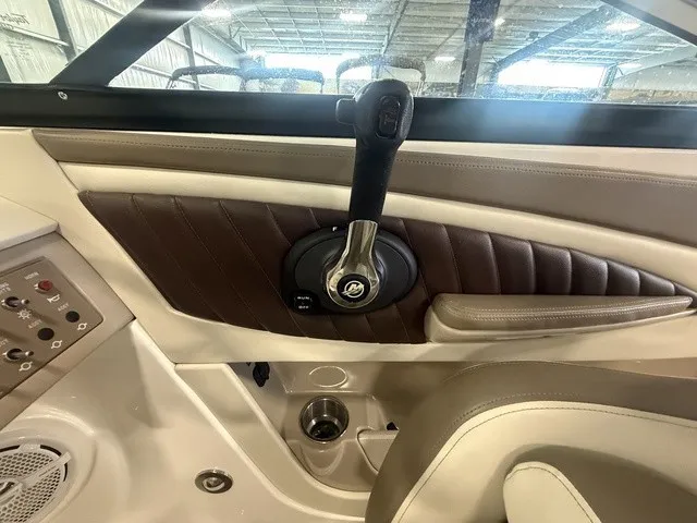 Slide: The Image of Close-up of the helm area in a 2013 Sea Ray SLX 230 boat, featuring sleek details. - 13