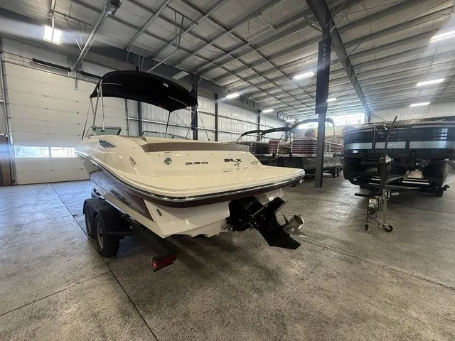 Slide: The Image of A 2013 Sea Ray SLX 230 boat is on a trailer in a warehouse. - 4
