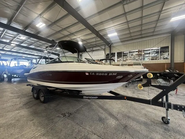 Slide: The Image of A 2013 Sea Ray SLX 230 boat on a trailer inside a warehouse. - 3