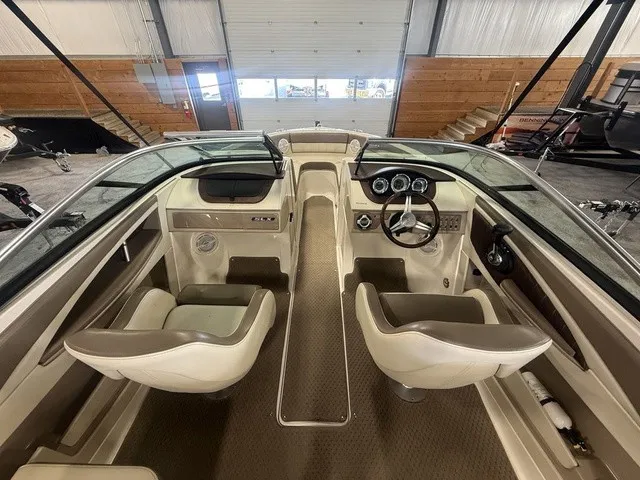 Slide: The Image of The image shows the cockpit of a 2013 Sea Ray SLX 230 with two seats and a steering wheel. - 9