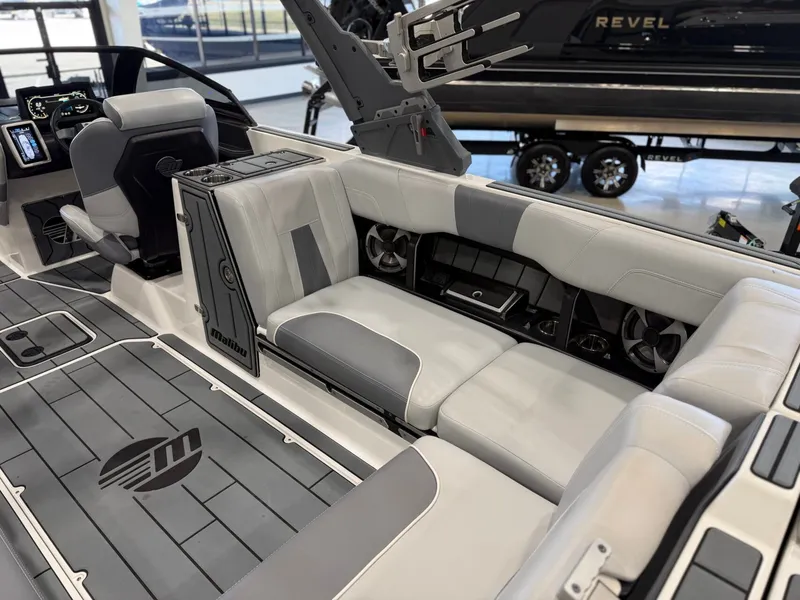 Slide: The Image of The image shows the luxurious interior of a 2021 Malibu Wakesetter 24 MXZ with gray upholstery. - 12