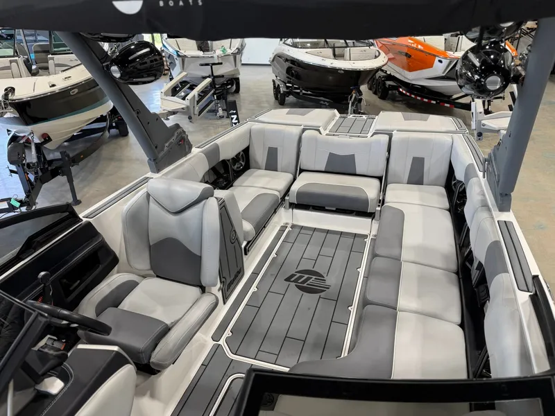 Slide: The Image of The image shows the interior of a 2021 Malibu Wakesetter 24 MXZ with gray upholstery. - 25