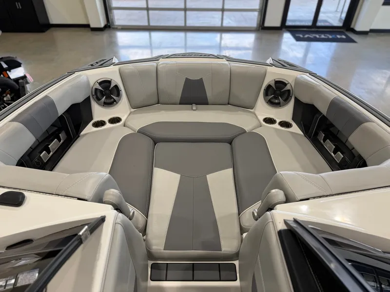 Slide: The Image of The image shows the bow area of a 2021 Malibu Wakesetter 24 MXZ with gray upholstery and speakers. - 16