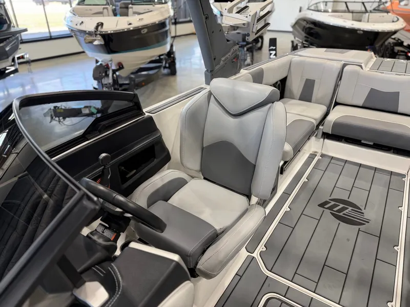 Slide: The Image of The image shows the cockpit of a 2021 Malibu Wakesetter 24 MXZ with gray upholstery. - 20
