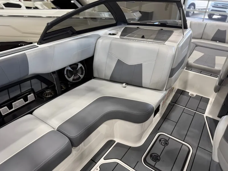 Slide: The Image of The image shows the interior of a 2021 Malibu Wakesetter 24 MXZ with gray upholstery. - 13