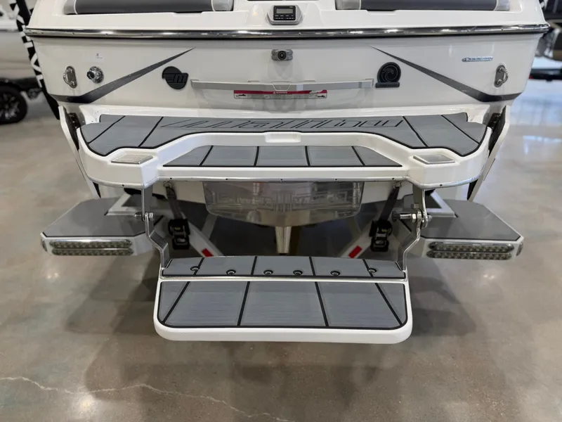 Slide: The Image of The image shows the rear of a 2021 Malibu Wakesetter 24 MXZ with fold-out platforms. - 8