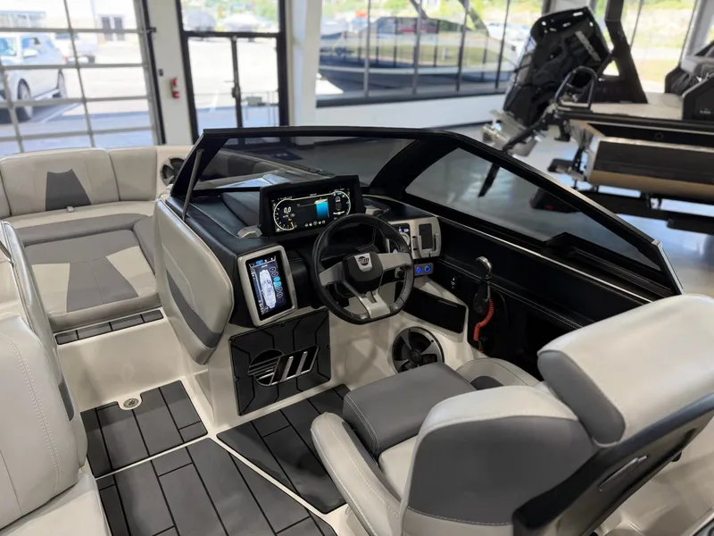 Slide: The Image of The image shows the cockpit of a 2021 Malibu Wakesetter 24 MXZ with modern instruments. - 14