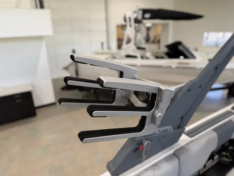 Slide: The Image of A boat in a showroom featuring a modern wakeboard rack. - 23