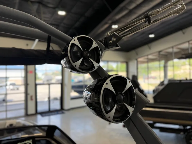 Slide: The Image of Close-up of speakers on a Malibu Wakesetter 24 MXZ, in a modern showroom. - 21