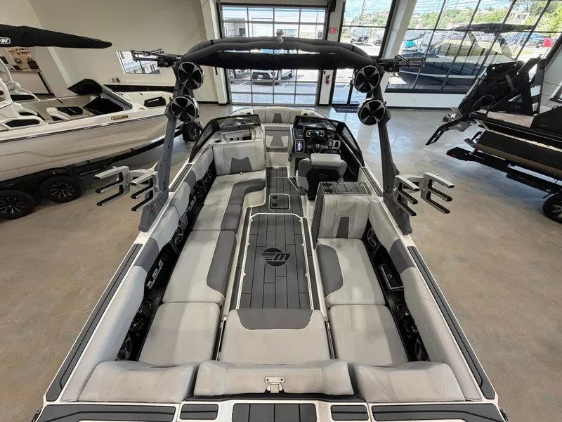 Slide: The Image of The image shows the interior of a 2021 Malibu Wakesetter 24 MXZ with gray upholstery and modern speakers. - 10