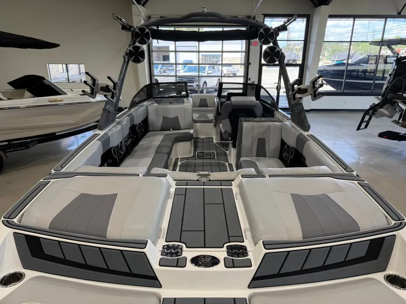 Slide: The Image of The image shows the interior of a 2021 Malibu Wakesetter 24 MXZ with gray and black seating. - 9